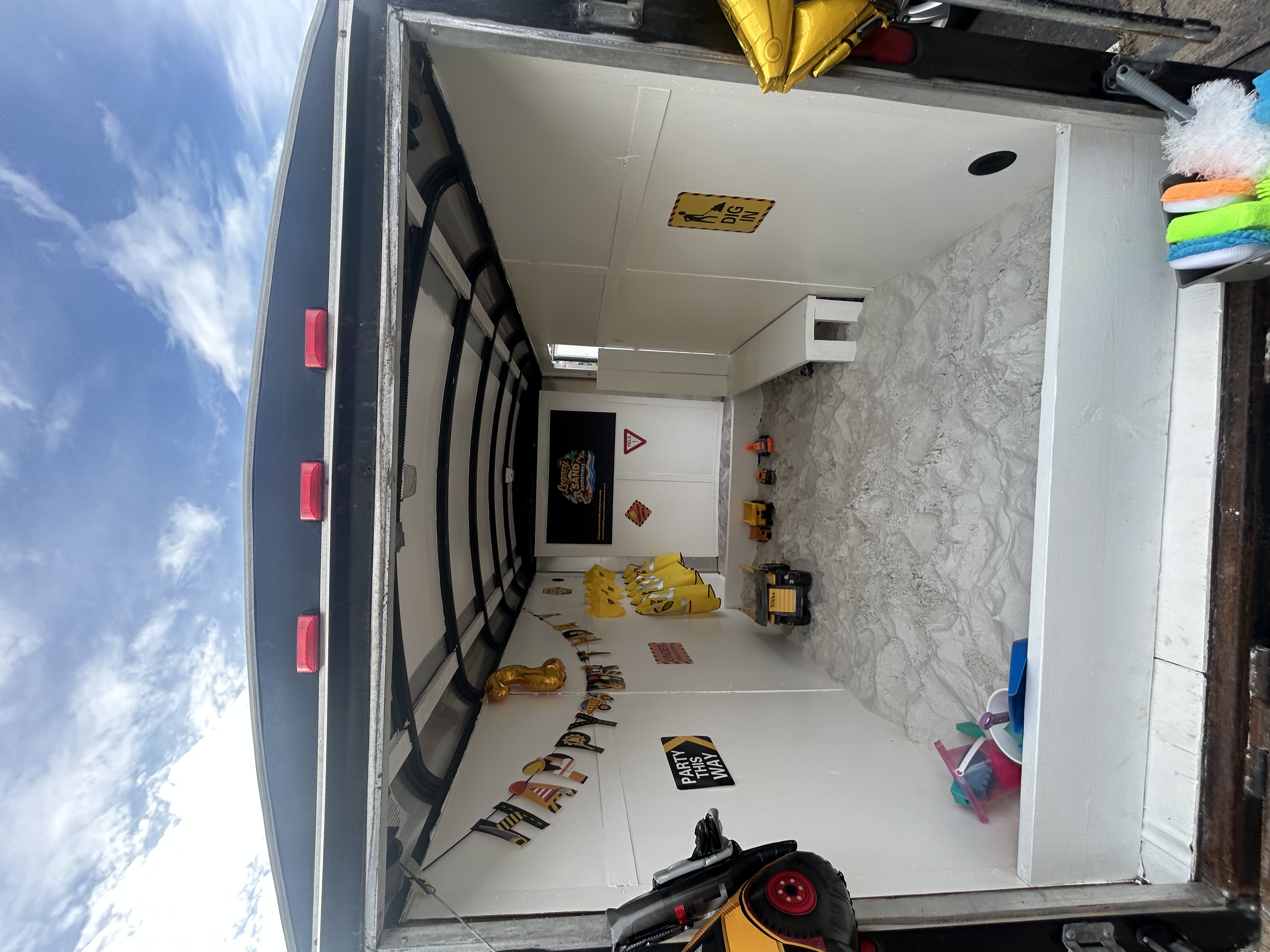 Inside the Legacy Sand Adventures mobile trailer, fully set up for a birthday party